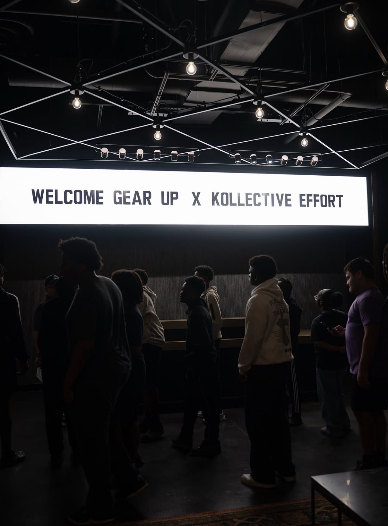 Youth gathered under a Welcome Gear Up x Kollective Effort sign